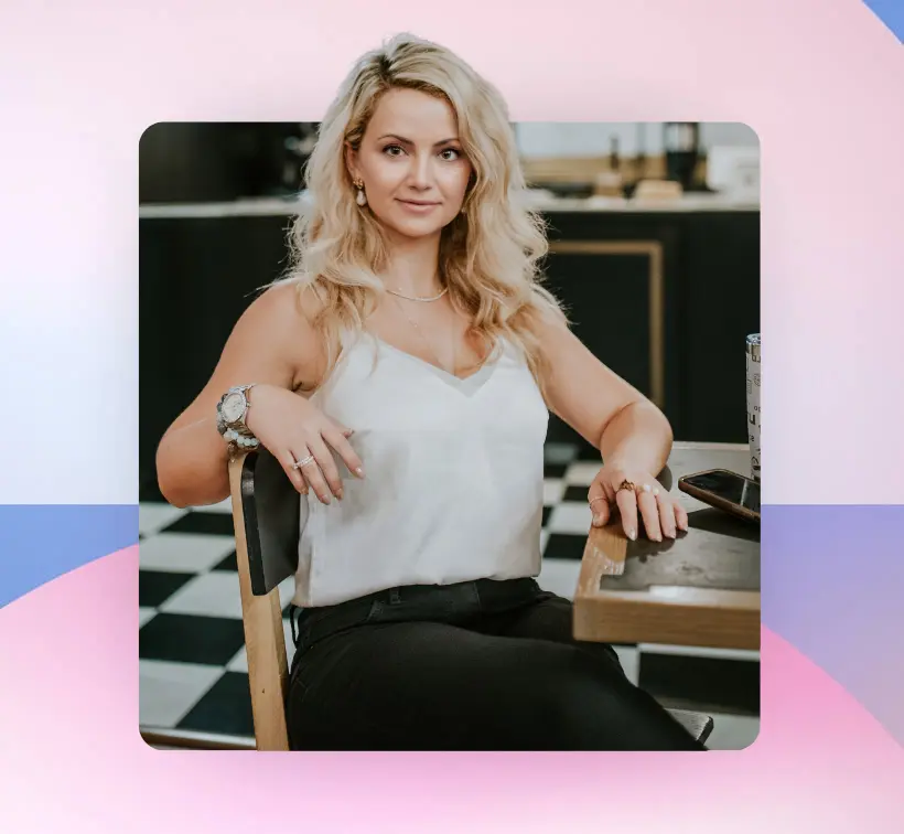 Gogo Bethke sits at a table in a stylish, modern setting.