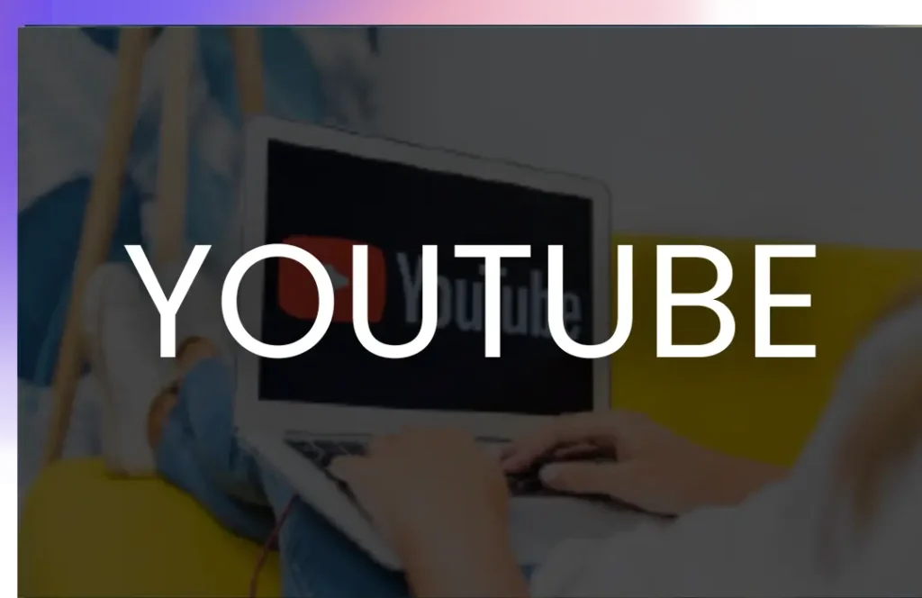 A person typing on a laptop with the YouTube logo displayed on the screen, overlaid with the word "YOUTUBE" in bold white letters.